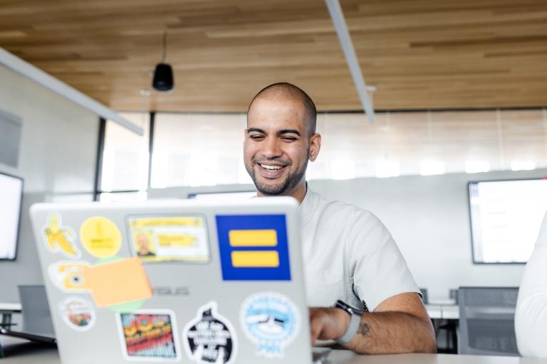 Man smiling on his laptop